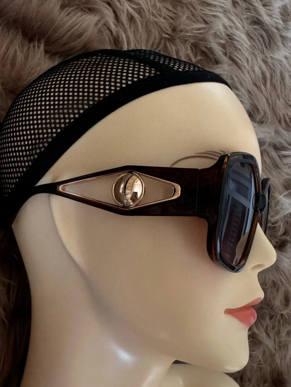 Futuristic sunglasses with large button detail on the sides